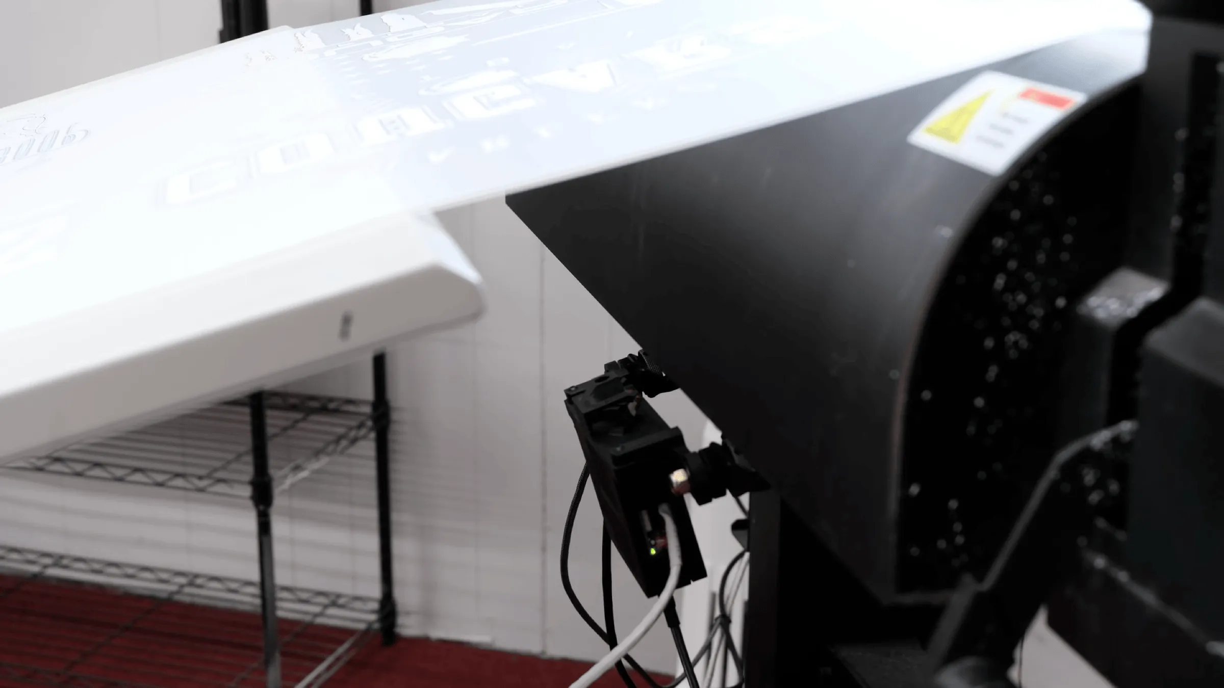 A Shelfmark inspection camera mounted beneath a printed sheet on a digital press